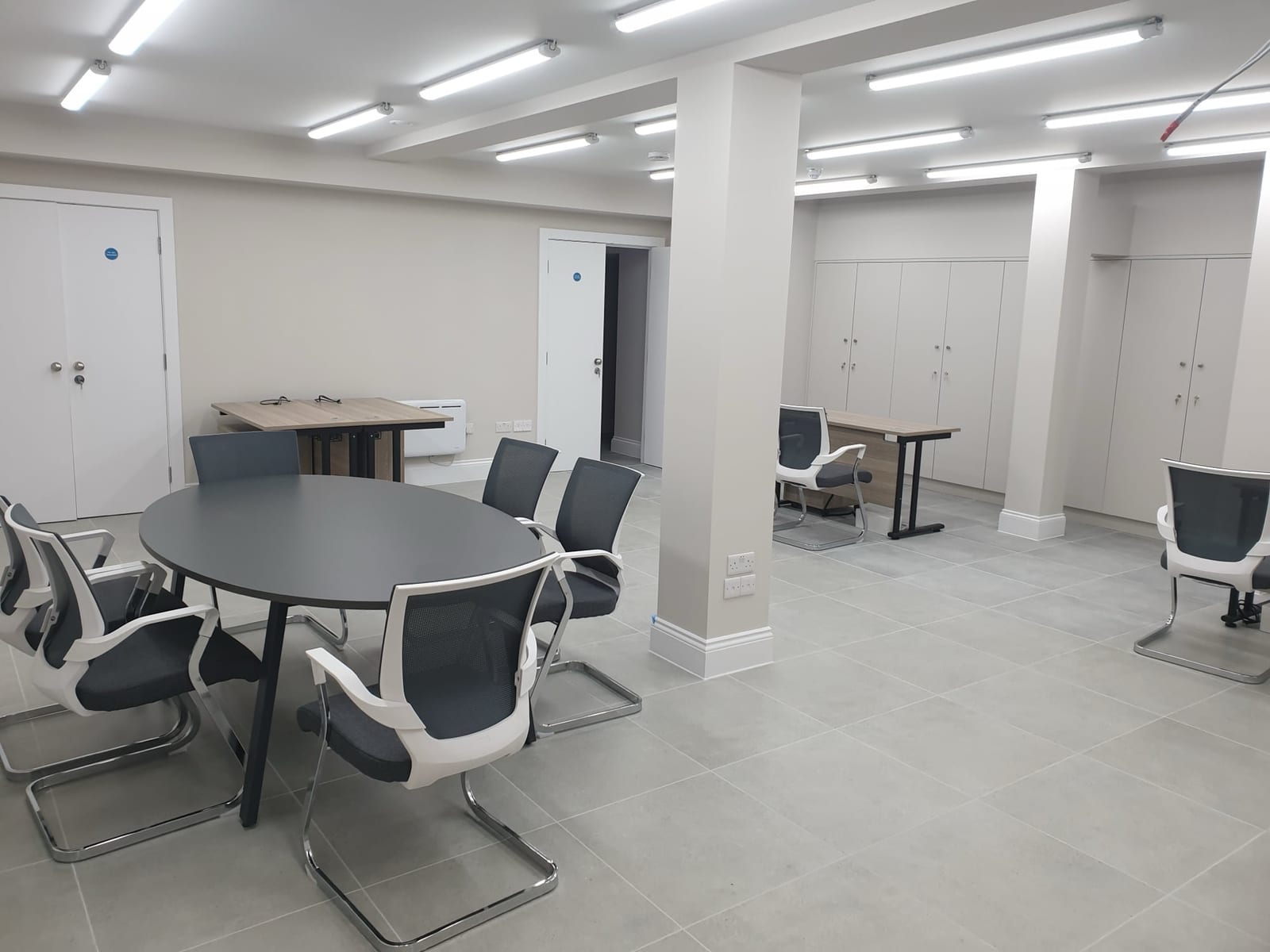 Freshly finished commercial interior with bright walls and fitted storage.